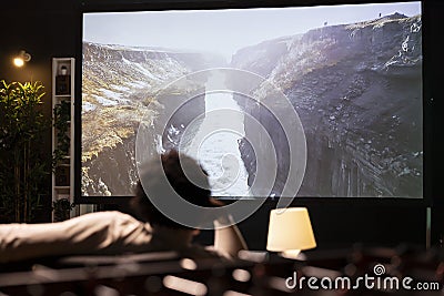 Person enjoying scenery shots on video on demand television channel Stock Photo