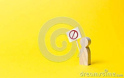 person figure with a sign with symbol NO on an yellow background. Social discontent and social tension, protest and disagreement. Stock Photo