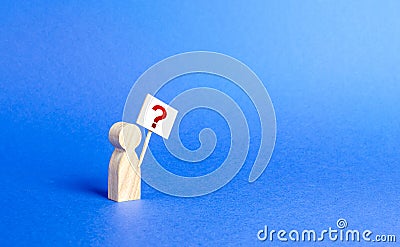 A person figurine with a question mark. Minimalism. Asking, searching for truth and demanding truth. Curiosity, desire to learn Stock Photo