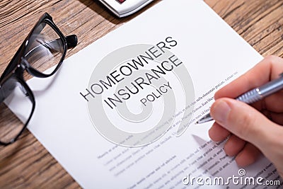 Person Filling Homeowners Insurance Policy Form Stock Photo