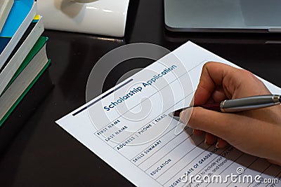 Person filling out scholarship application Stock Photo