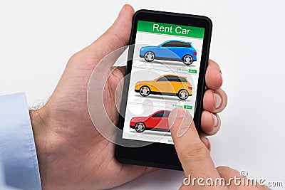 Person Holding Cellphone With Colorful Cars On Screen Stock Photo