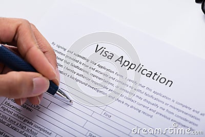 Person Filling Visa Application Form Stock Photo