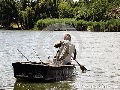 Person Fishing in the River from a boat Stock Photo