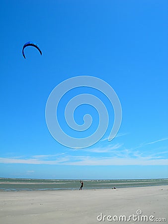 Person flying kite on beach Stock Photo