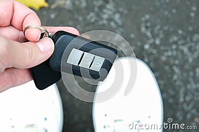 A person found and picked up from the ground lost car auto keys Stock Photo