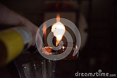 Person glass blowing in the workshop Stock Photo