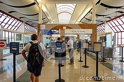 Person going through TSA Precheck line and regular line through airport security Editorial Stock Photo
