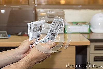 Person hand accept money bribe from construction project,corruption concept Stock Photo