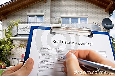 Person Hand Filling Real Estate Appraisal Document Stock Photo