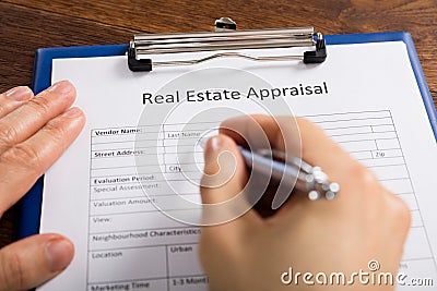 Person Hand Filling Real Estate Appraisal Form Stock Photo