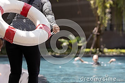 Person hand holding ringbuoy to rescue drowning in dangerous situation on summer vacation,asian child girl struggling in water, Stock Photo