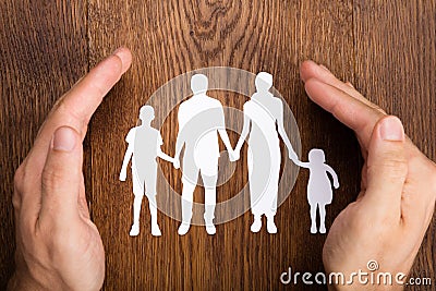 Person Hand Protecting Family Papercut Stock Photo