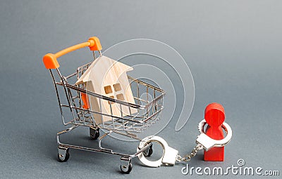A person is handcuffed to a house on a supermarket cart. Financial dependence, unavailable housing for young families. Freeze of Stock Photo
