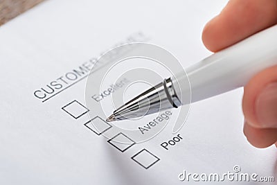 Person Hands Filling Customer Survey Form Stock Photo