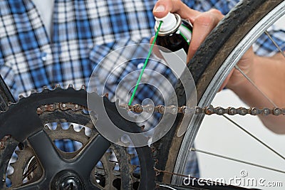 Person Hands Lubricating Bike Stock Photo