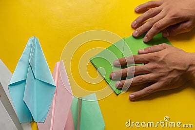 person hands making a origami color paper planes Stock Photo