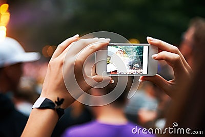 Person, hands and music festival or cellphone picture or entertainment stage, party concert or crowd audience. Woman Stock Photo