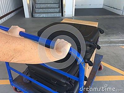 Person hands push trolley luggage Stock Photo