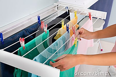 Person Hanging Wet Cloth On Clothes Line Stock Photo