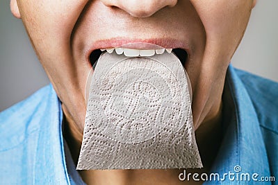 A person has toilet paper instead of a tongue. Concept on the topic of sycophancing Stock Photo