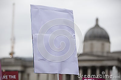 A person holding a blank protest banner at a political rally Stock Photo