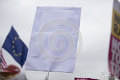 A person holding a blank protest banner at a political rally Stock Photo