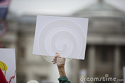 A person holding a blank protest banner at a political rally Stock Photo