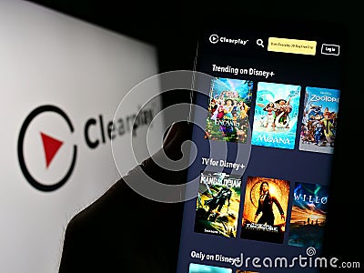 Person holding cellphone with webpage of parental control company Clearplay Inc. on screen in front of logo. Editorial Stock Photo