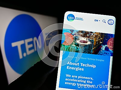 Person holding cellphone with website of French engineering company Technip Energies N.V. on screen with logo. Editorial Stock Photo