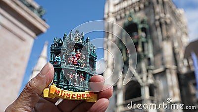 person holding a colorful refrigerator magnet of Munich, Germany Stock Photo