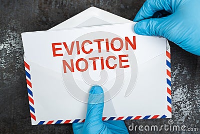 Person Holding Eviction Notice In Envelope Stock Photo