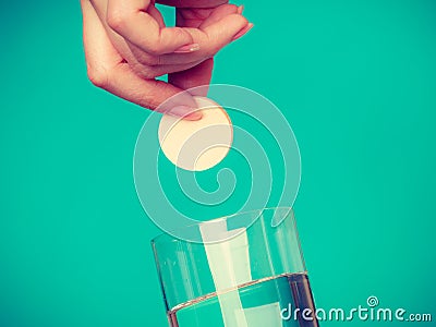 Person holding glass with water and effervescent tablet Stock Photo