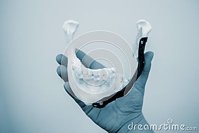 Person holding in hand facial mandibular endoprosthese printed metal 3D printer Stock Photo