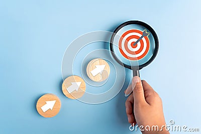 Person holding a magnifying glass focus business growth success achievement concept, customer target group concept Stock Photo