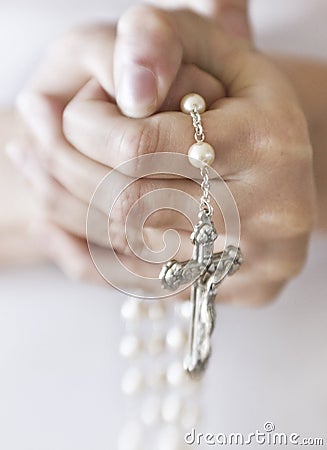 Person holding rosary beads Stock Photo