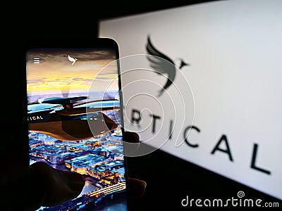 Person holding smartphone with website of British aircraft company Vertical Aerospace Ltd. on screen with logo. Editorial Stock Photo