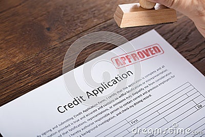 Person Holding Stamp On Credit Application Form Stock Photo