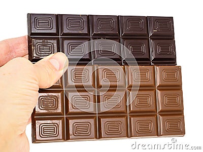 Person holding two whole bars of light and drak chocolate Stock Photo