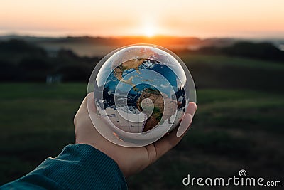 Person holds globe, symbolizing global perspective and foresight for future Stock Photo