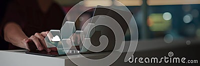 A person is interacting with a laptop, where a virtual cloud icon is part of a hexagonal digital interface. Stock Photo