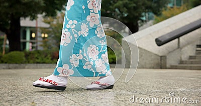 Person, Japanese and feet walking in kimono in city or local commute or traditional, outdoor or downtown. Legs, sandals Stock Photo