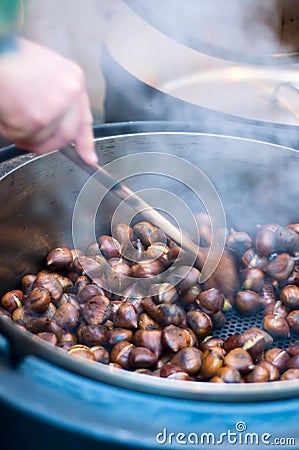 Person makes Roasted Chestnut Stock Photo