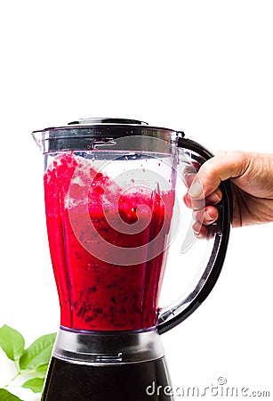 Person making cherry smoothie with a blender Stock Photo