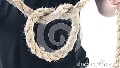 Person male hands tie a bowline knot in a piece of rope Stock Photo