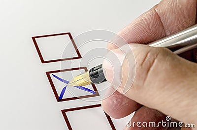 Person Marking in a Checkbox on white paper. Stock Photo