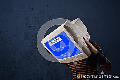 Person with a monitor head and fatal error blue screen on the di Stock Photo