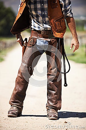 Person, outdoors and gun ready to shoot for standoff or gunfight in duel for wild western culture in Texas. Cowboy Stock Photo