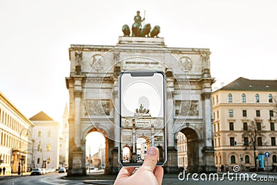 The person photographs for memory the Victory Triumphal Arch in Munich Stock Photo