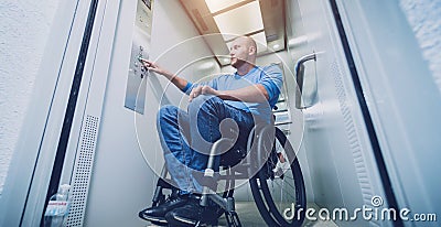 Person with a physical disability who uses wheelchair using lift in building Stock Photo